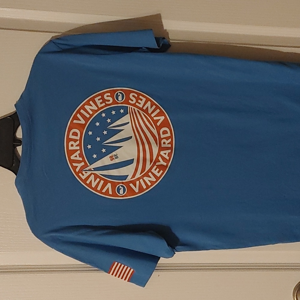 Vineyard Vines Blue T with Sailboat on pocket and back; American flag on sleeve